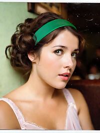 A woman clad in 1980s fashion and hairstyles wears a bright pink wedding dress